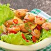 Shrimp salad with peaches, tomato, avocado and lettuce